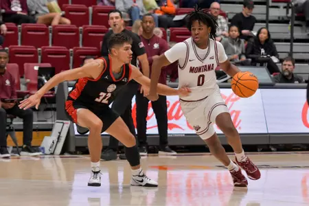 Money Williams #0 of the Montana Grizzlies dribbles down the court during the second half of a college basketball game between the Montana Grizzlies and the Northwest Indian College Eagles at Robin Selvig Court inside Dahlberg Arena on November 7, 2023 in Missoula, Montana.