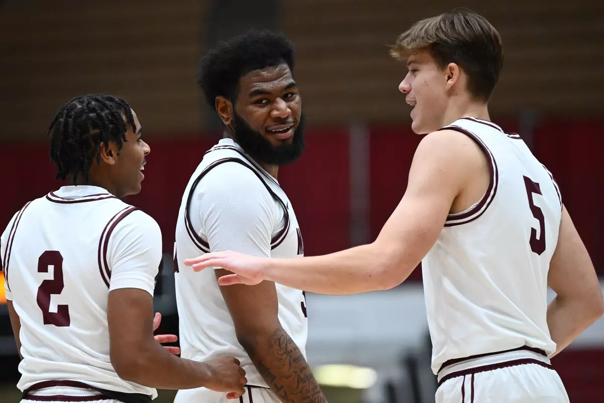 Chase Henderson #2, Jaxon Nap #5 and Te?Jon Sawyer #32 of the Montana Grizzlies talk after scoring against the San Jose State Spartans at Robin Selvig Court inside Dahlberg Arena on December 2, 2023 in Missoula, Montana.