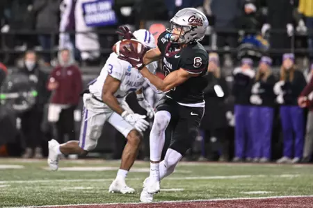 Keelan White #6 of the Montana Grizzlies scores a touchdown during overtime against the Furman Paladins at Washington-Grizzly Stadium on December 8, 2023 in Missoula, Montana.