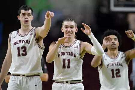 Josh Bannan #13, Aanen Moody #11 of and Brandon Whitney #12 of the Montana Grizzlies react to a technical foul called in the second half of a game against the Idaho State Bengals on March 6, 2023 in Boise, Idaho.