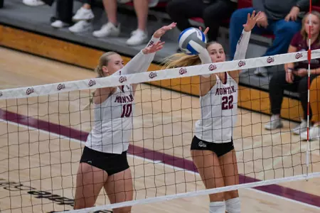 Maddie Kremer #22 of the Montana Grizzlies and Ellie Scherffius #10 go for a block during the second set of a college volleyball match between the Montana Grizzlies and the Weber State Wildcats at Dahlberg Arena on September 20, 2023 in Missoula, Montana.