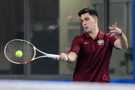 Fernando Perez returns a serve during a set of a doubles tennis match against the Whitworth Pirates at the PEAK Racquet Club on January 20, 2024 in Missoula, Montana.