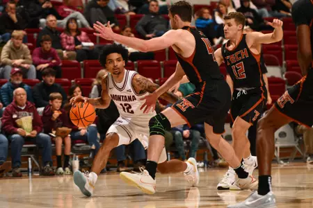 Brandon Whitney #12 of the Montana Grizzlies dribbles down court during the first half between the Montana Grizzlies and Montana Tech at Robin Selvig Court inside Dahlberg Arena on December 10, 2024 in Missoula, Montana.