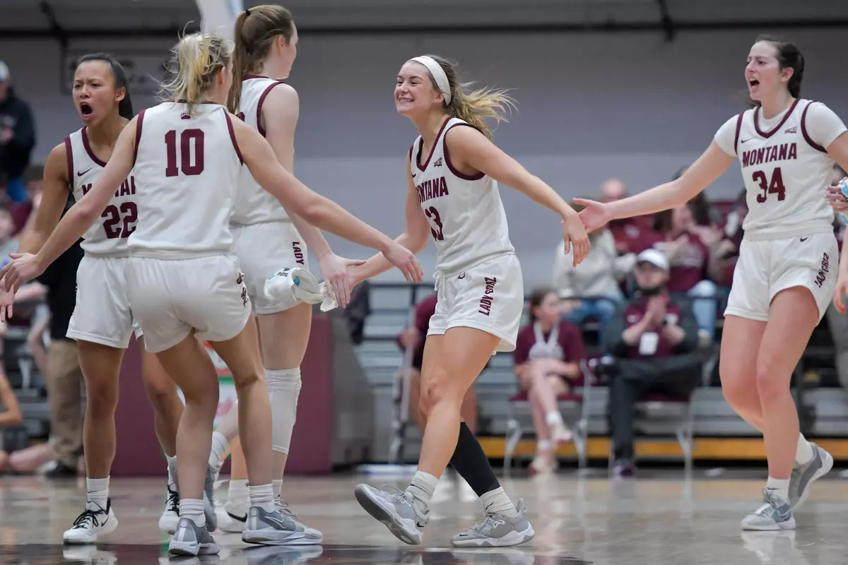 Maggie Espenmiller-McGraw #13 of the Montana Grizzlies celebrates during timeout in the second quarter of a game against the Northern Colorado Bears at Robin Selvig Court inside Dahlberg Arena on February 10, 2024 in Missoula, Montana.