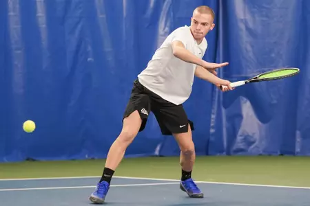 Dragos Bucurescu of The Montana Grizzlies hits the ball during a match against the Whitman Blues on Feb. 10, 2024 at the PEAK Racquet Club in Missoula, Montana.