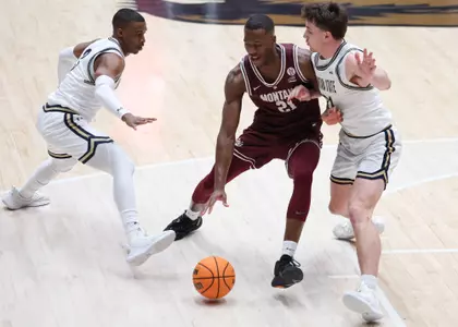 Laolu Oke dribbles the ball during the first half of a game against the Montana Grizzlies and the Montana State Bobcats on February 17, 2024, in Dahlberg Arena, Missoula, Montana.