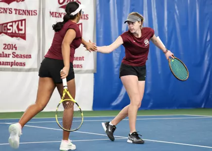 Rosie Sterk and Shivika Agrawal of the Montana Grizzlies celebrate during a match against the Utah State Aggies on Feb. 16, 2024, at the PEAK Racquet Club in Missoula, Montana.