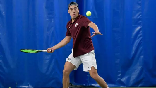 Chris Zhang of the Montana Grizzlies hits the ball during a tennis match against the Grand Canyon Lopes at PEAK Racquet Club on February 4, 2024 in Missoula, Montana.