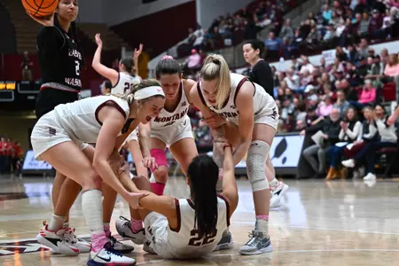 The Lady Griz help Gina Marxen #22 of the Montana Grizzlies off the floor after being fouled by Eastern Washington University at Dahlberg Arena on February 29, 2024 in Missoula, Montana.