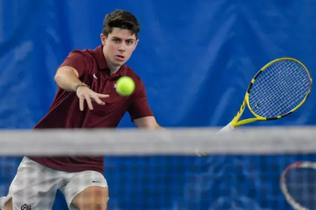 Guillermo Martin of the Montana Grizzlies stares down the ball before hitting it during a tennis match against the Grand Canyon Lopes at PEAK Racquet Club on February 4, 2024 in Missoula, Montana.