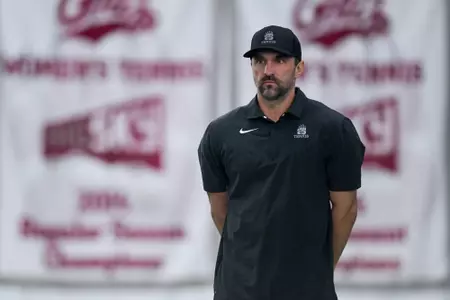 Head coach Jason Brown of the Montana Grizzlies looks on during a tennis match against the Grand Canyon Lopes at PEAK Racquet Club on February 4, 2024 in Missoula, Montana.