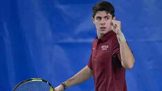 Guillermo Martin of the Montana Grizzlies celebrates after winning a point during a tennis match against the Grand Canyon Lopes at PEAK Racquet Club on February 4, 2024 in Missoula, Montana.