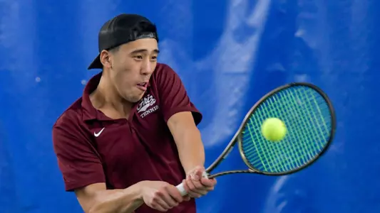 Chris Zhang returns a serve during a set of a singles tennis match against the Whitworth Pirates at the PEAK Racquet Club on January 20, 2024 in Missoula, Montana.
