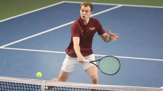 Baltazar Wiger-Nordas of the Montana Grizzlies hits the ball during a match against the Grand Canyon Lopes at PEAK Racquet Club on February 4, 2024, in Missoula, Montana.