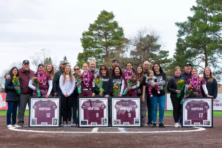 The Montana Grizzlies celebrate their senior players before a game against the Portland State Vikings at the University of Montana Softball Field on April 21, 2024 in Missoula, Montana.