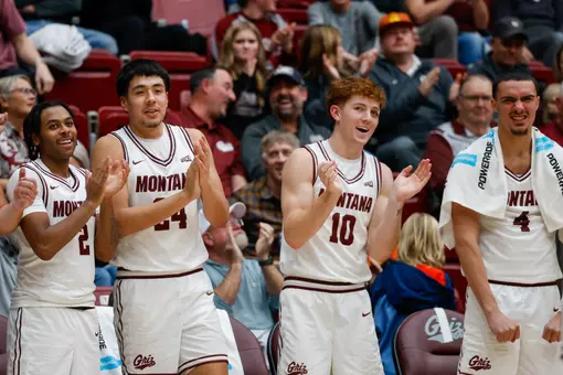 The Griz bench cheers for their team after a play during the basketball game between the Montana Grizzlies and the Cal Poly Mustangs in Dahlberg Arena, in Missoula, MT, on November 14, 2025.