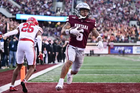 Michael Wortham #6 of the Montana Grizzlies scores a fourth quarter touchdown against the South Dakota Coyotes at Washington-Grizzly Stadium on December 13, 2025 in Missoula, Montana.