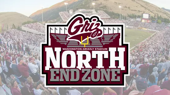 A wide angle shot of the Griz football team taking on an opponent inside Washington Grizzly Stadium under the lights.