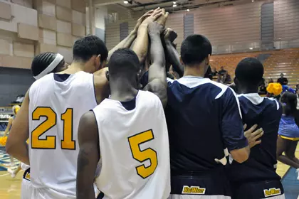2010-11 Men's Basketball Team Huddle Hands Raised