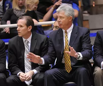 Jim Wooldridge and Dennis Cutts seated on bench