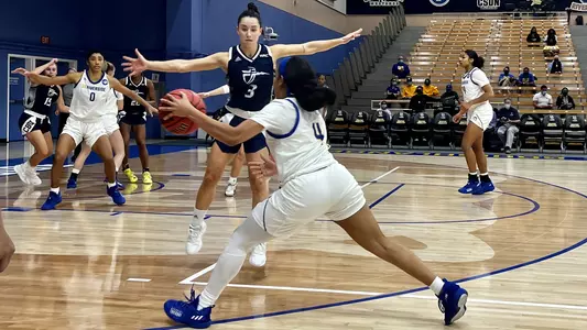 Jada Holland feeds Matehaya Bryant against Cal Baptist.