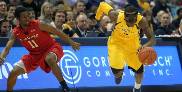 Todd Mayo dribbles the ball upcourt against Samford