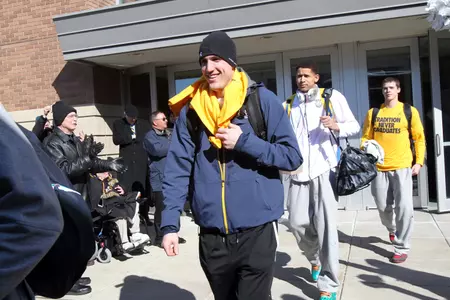 Jake Thomas, Juan Anderson and the rest of the Golden Eagles board the team bus outside the Al McGuire Center Tuesday.