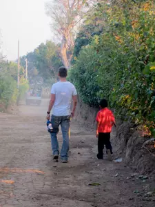 A.J. Gedwill and a local boy on a dirt road in the village of San Luis de Los Ranchos.
