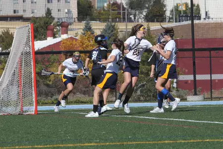 Marquette's roster includes native Michiganders Lauren Hooker (center) and Abigail Esch (right) in addition to freshman Meghan Wilson.