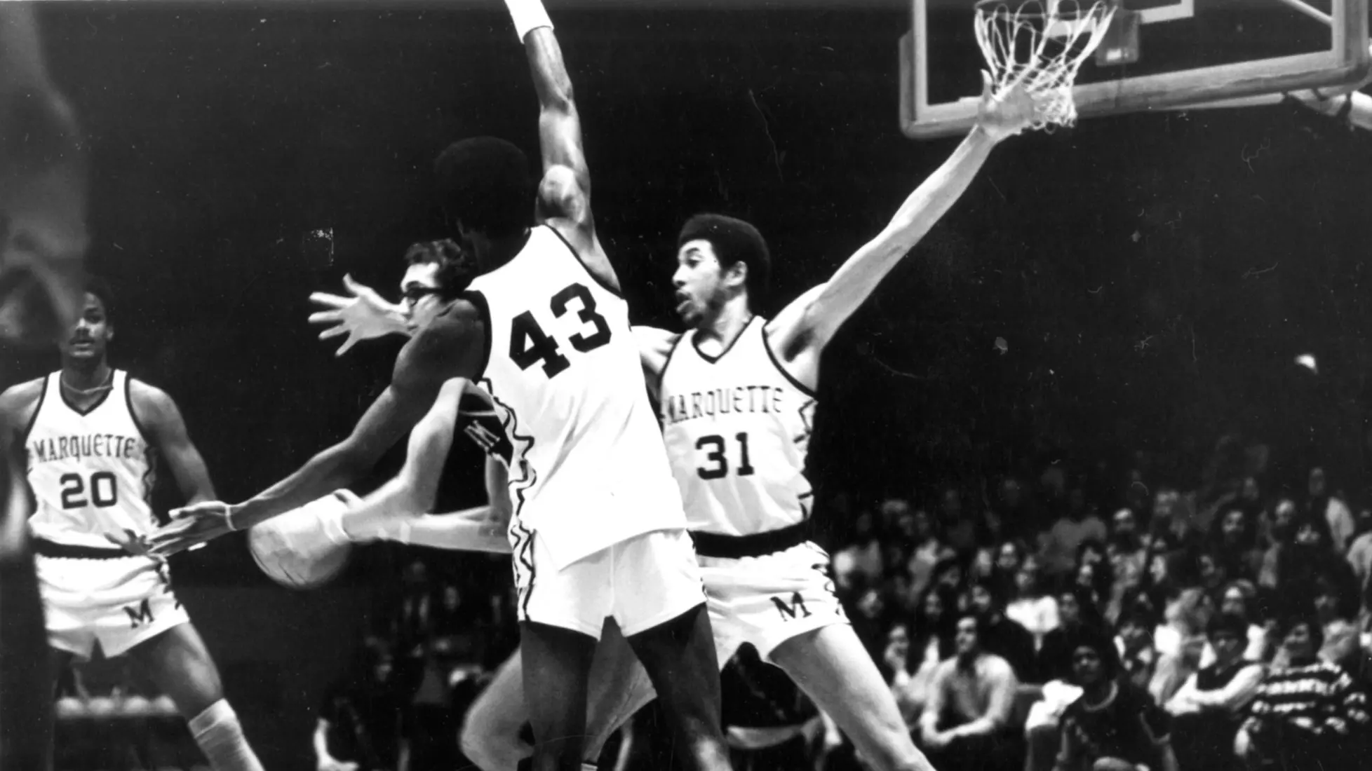 Marquette basketball players Bo Ellis (#31), Maurice Lucas (#20), and Earl Tatum (#43) play defense against an oppoent, 1973 or 1974.
Bo Ellis, Earl Tatum, Males, Maurice Lucas, Men's Basketball, Students