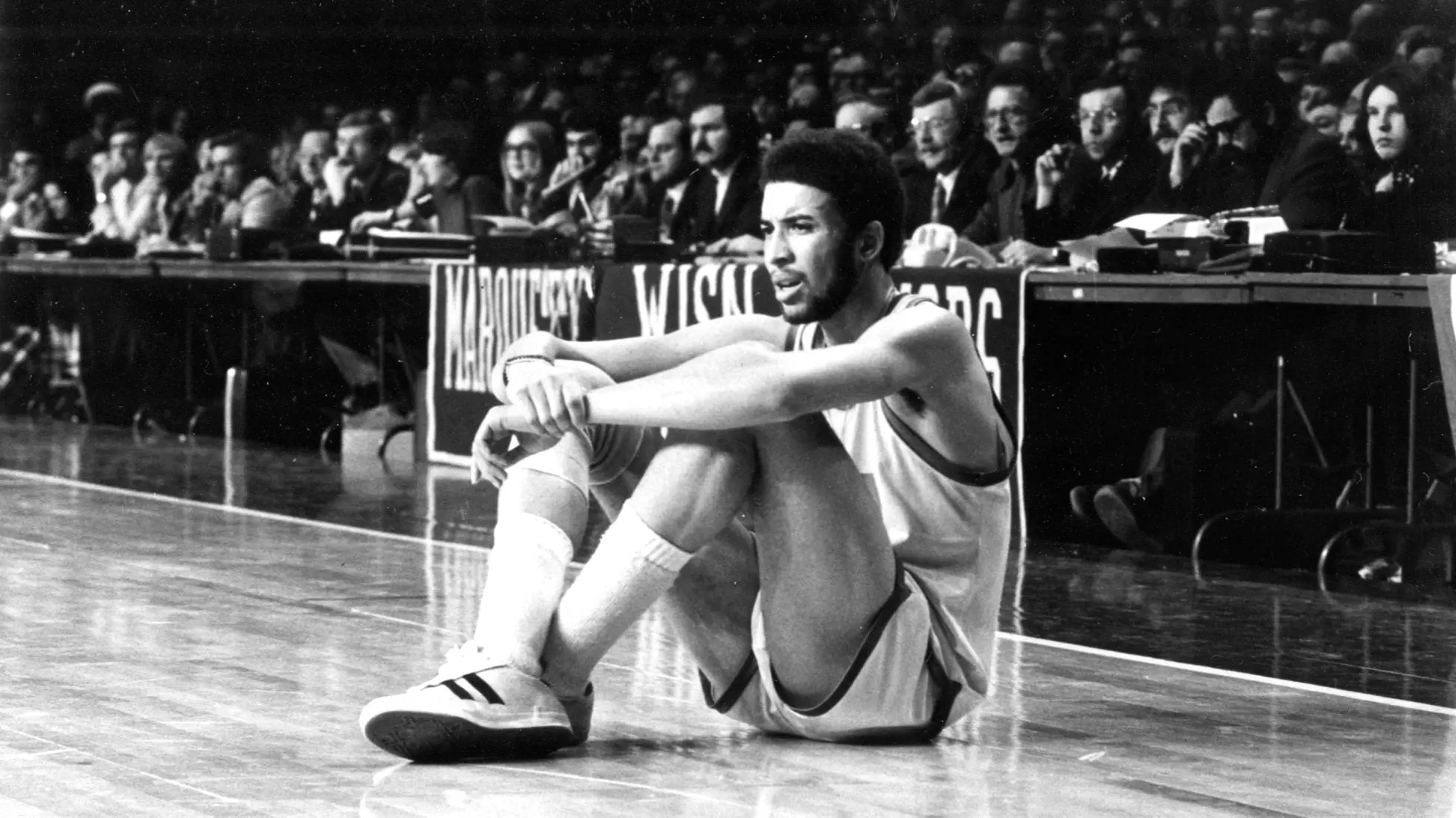 Bo Ellis sits along the sidelines at a home basketball game, 1974-1975.
Bo Ellis, Diversity, Men's Basketball