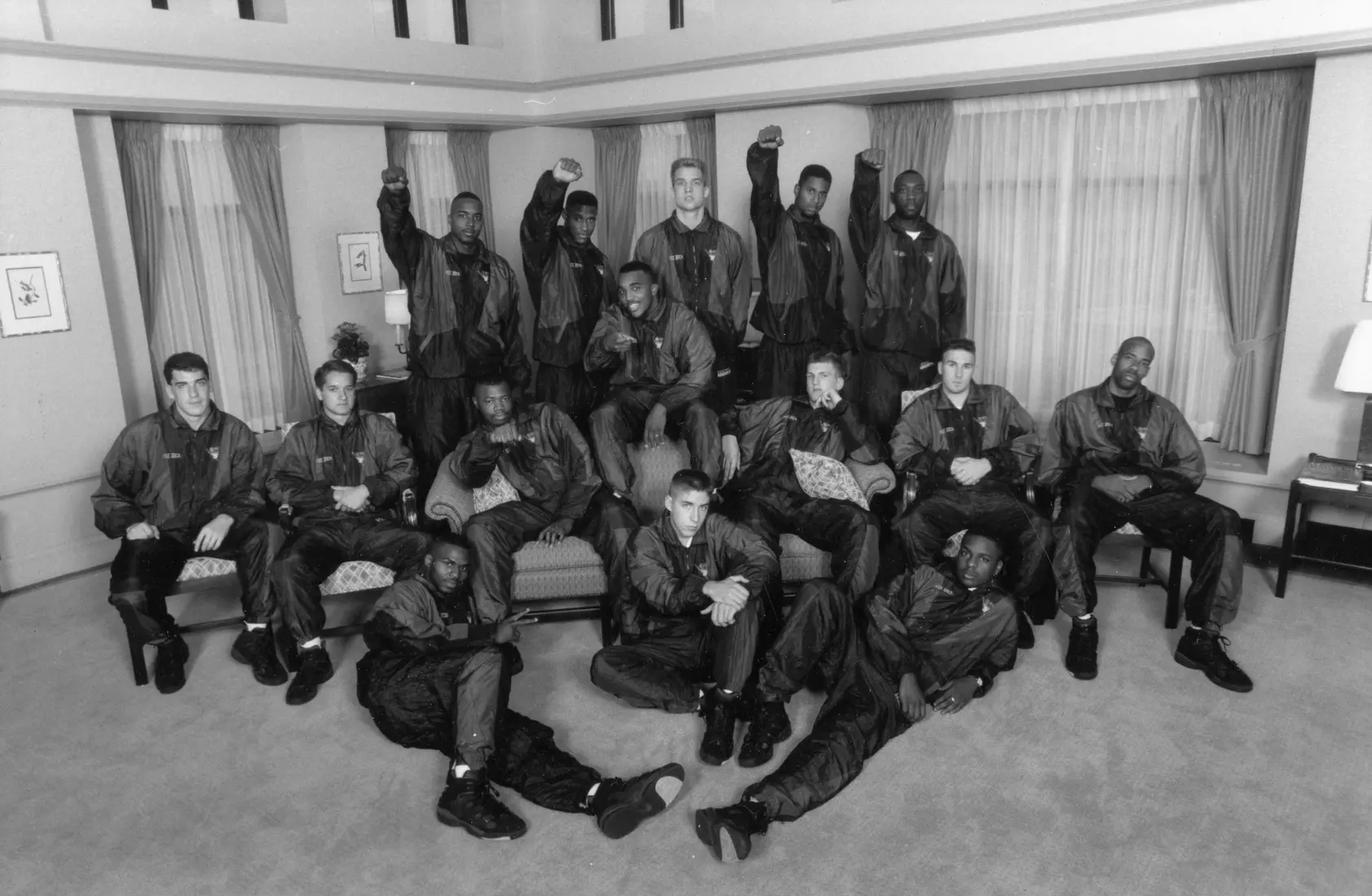 The Marquette men's basketball team poses in the Trustees' board room in the AMU, 1993. Members of the team that year included Roney Eford, Damon Key, Jim McIlvaine, Tony Miller, Robb Logterman, Amal McCaskill, Anthony Pieper, Faisal Abraham, Abel Joseph, Carl Hren, Shane Littles, Joel Pogodzinski, William Gates, Chris Crawford, and Dwaine Streater.