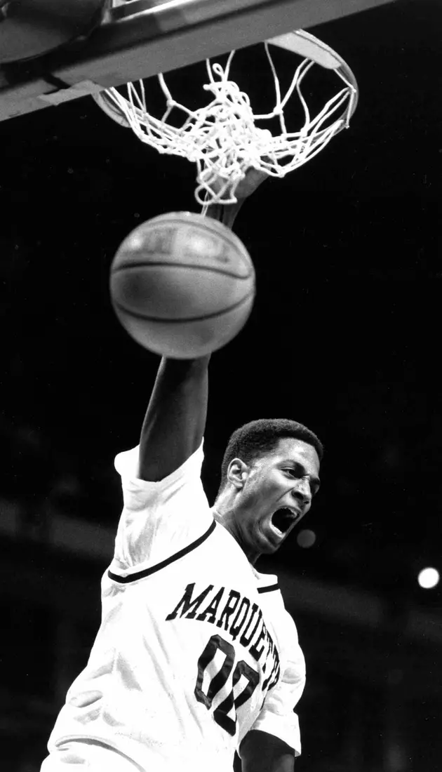 Marquette player Amal McCaskill dunks the basketball, 1994