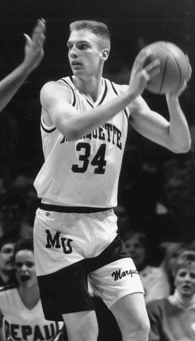 Marquette basketball player Jim McIlvaine scans the court looking to pass the ball, 1990-1994.