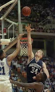 Marquette University men's basketball players Jim McIlvaine and Damon Key play defense against Antonio Lang during the NCAA Tournament Sweet 16 game against Duke, March 24, 1994.