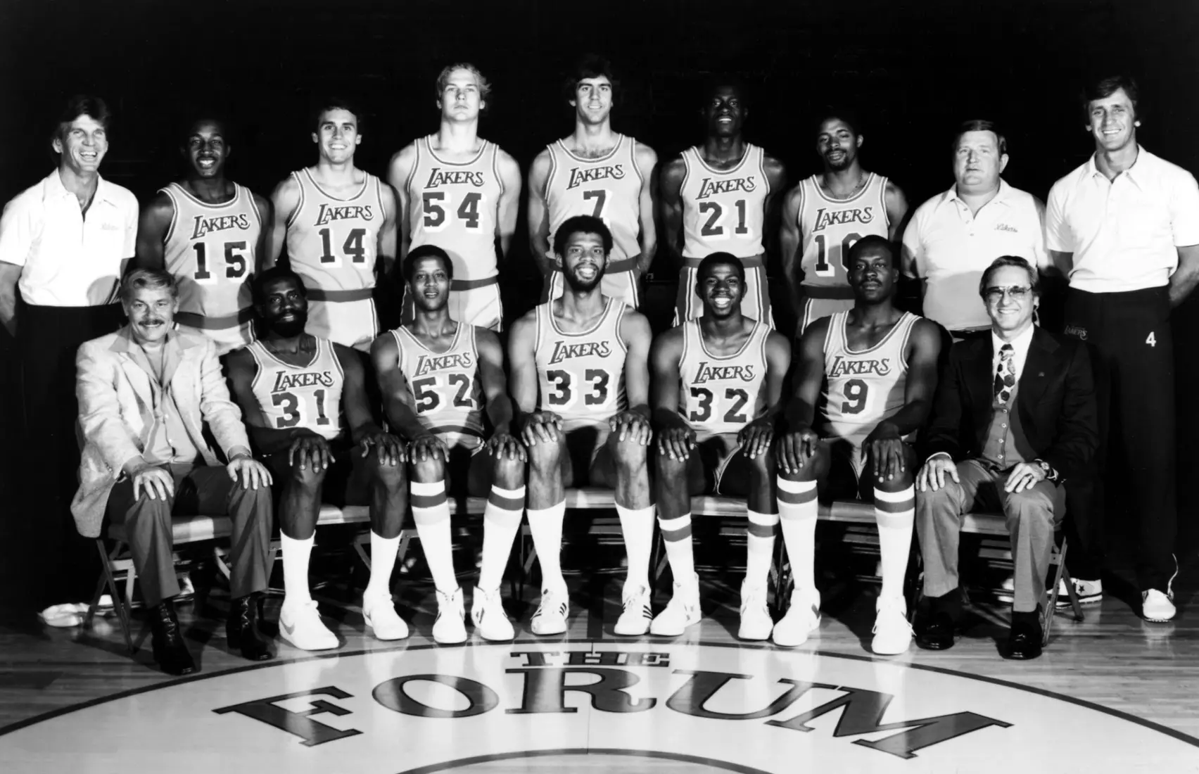 INGLEWOOD, CA - 1980: The World Champions of basketball Los Angeles Lakers pose for a team portrait seated (L-R): Chairman of the Board Dr. Jerry Buss, Spencer Haywood, Jamaal Wilkes, Kareem Abdul-Jabbar, Earvin Johnson, Jim Chones, G. M. Bill Sharman. Back Row: Head Coach Paul Westhead, Butch Lee, Brad Holland, Mark Landsberger, Marty Byrnes, Michael Cooper, Norm Nixon, Trainer Jack Curran, Asst. Coach Pat Riley at the Great Western Forum in Inglewood, California circa 1980. NOTE TO USER: User expressly acknowledges and agrees that, by downloading and or using this photograph, User is consenting to the terms and conditions of the Getty Images License Agreement. Mandatory copyright notice: Copyright NBAE 2002 (Photo by NBAP/ NBAE/ Getty Images)