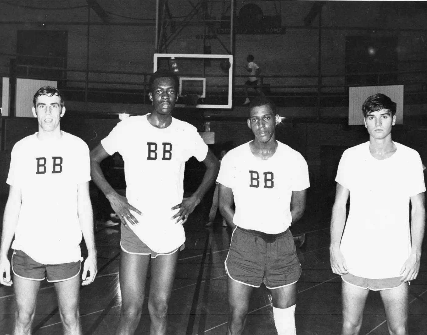 Marquette basketball player Jim Chones (second from left) and teammates pose in a line in the gymnasium, 1970-1972.