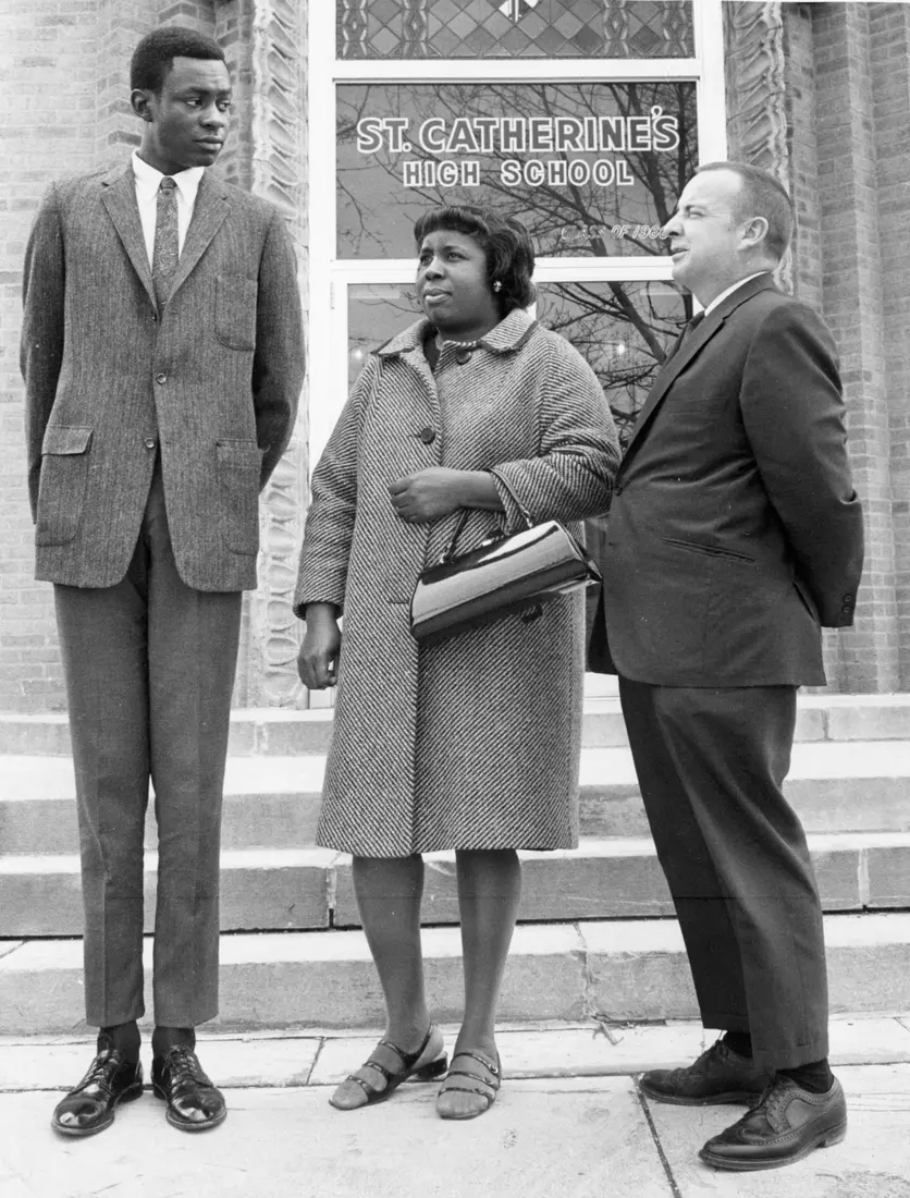 Marquette basketball player Jim Chones poses with his mother and coach, John McGuire, outside St. Catherine's High School, circa 1970.