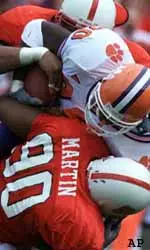 Clemson tailback Bernard Rambert, middle, is stopped for a loss by North Carolina State defender Terrance Martin (90) in the first quarter.