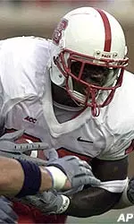 North Carolina State's Jerricho Cotchery makes his way past the defense of Southern Methodist University during the first half.
