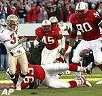 Jerrick Hall (93) blocks a punt by Florida State's Chance Gwaltney (37) as teammates Dantonio Burnette (45) and Terrance Martin (90) close in during the first quarter.