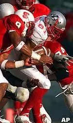 Terrence Holt, left, and Craig Moody wrap up New Mexico's Terrence Thomas.