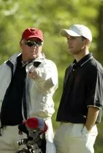 Coach Richard Sykes, left, and senior Fernando Mechereffe talk over a hole at the Raleigh Country Club.