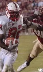 Receiver Jerricho Cotchery stiff-arms FSU's Stanford Samuels as he runs for third-quarter yardage.