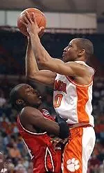 NC State forward Julius Hodge, left, draws a foul as Clemson's Edward Scott attempts a shot in the first half.