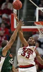 Cedric Simmons blocks the shot of Miami's Raymond Hicks during the first half. (AP Photo/ Karl DeBlaker)