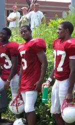 Wide receivers Lamart Barrett, Sterling Hicks and Brian Clark take a rare break during a recent practice.