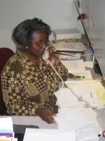 Media Relations program assistant Caffie Darden orders phone lines for Vaughn Towers.