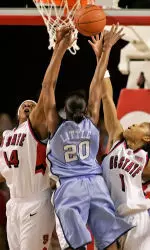 Tiffany Stansbury and Khadijah Whittington contest Camille Little's shot in the first half. (AP Photo/Karl DeBlaker)