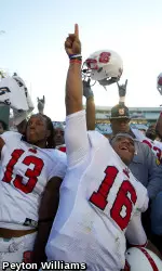 NC State's football team celebrates its win over North Carolina.